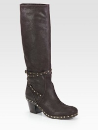 A tall leather design finished with metal goldtone studs for an edgy look. Stacked heel, 2¼ (60mm)Shaft, 15Leg circumference, 13Leather upper with metal studsLeather lining and solePadded insoleMade in ItalyThis style runs small. We recommend ordering one size up for a standard fit. A tall leather design finished with metal goldtone studs for an edgy look. Stacked heel, 2¼ (60mm)Shaft, 15Leg circumference, 13Leather upper with metal studsLeather lining and solePadded insoleMade in ItalyThis style runs small. We recommend ordering one size up for a standard fit.