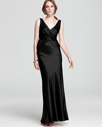 An open back with crisscross details lends glamorous allure to a stunning satin Nicole Miller gown. An open back with crisscross details lends glamorous allure to a stunning satin Nicole Miller gown.