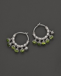 Inspired by Zen philosophy, these hoop earrings from Paul Morelli feature intricately detailed sterling silver meditation bells, set with peridot cabochons. Inspired by Zen philosophy, these hoop earrings from Paul Morelli feature intricately detailed sterling silver meditation bells, set with peridot cabochons.