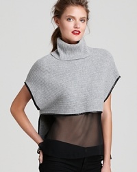Take your look in a modern direction with this cashmere and wool sweater-top, replete with luxe leather trim and a sheer silk bodice to reveal your svelte silhouette. Take your look in a modern direction with this cashmere and wool sweater-top, replete with luxe leather trim and a sheer silk bodice to reveal your svelte silhouette.