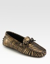 Moccasin-inspired silhouette of metallic leather takes on an exotic zebra print for a fashionable look. Zebra-print metallic leather upperLeather liningRubber solePadded insoleMade in Italy