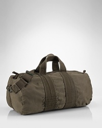 Washed and tumbled for a vintage look, this sturdy canvas duffle encourages owners to go the distance in style. Washed and tumbled for a vintage look, this sturdy canvas duffle encourages owners to go the distance in style.