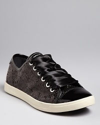 Dress up dressed-down styles with these DKNY sneakers, featuring shining ribbon laces, patent cap toes and trim and sparkling fabric. They're casual-meets-sensational. Dress up dressed-down styles with these DKNY sneakers, featuring shining ribbon laces, patent cap toes and trim and sparkling fabric. They're casual-meets-sensational.