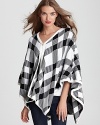 Bold and graphic, this plaid-perfect poncho balances sharp angles with soft drape to make a graphically chic style statement.