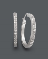 Hot hoops. Take this look to another level with hoop earrings accented by sparkling diamonds. Crafted in sterling silver. Approximate diameter: 1-1/4 inches. Hot hoops. Take this look to another level with hoop earrings accented by sparkling diamonds. Crafted in sterling silver. Approximate diameter: 1-1/4 inches.