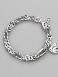 From the Cable Heart Collection. A lovely cable heart framed in pavé diamonds hangs from a figaro chain bracelet of sterling silver. Diamonds, 0.19 tcw Sterling silver Length, about 7½ Toggle closure Imported