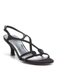 Slim straps and a chic little heel make these flirty sandals your LBD's new best friend. By Stuart Weitzman. Slim straps and a chic little heel make these flirty sandals your LBD's new best friend. By Stuart Weitzman.