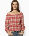 A soft woven cotton top channels western inspiration with a faded plaid pattern and smocked detailing.