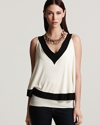 A layered Sweet Pea top boasts must-have color blocking, standing out in black and white for sharp, graphic style. A layered Sweet Pea top boasts must-have color blocking, standing out in black and white for sharp, graphic style.