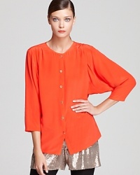 Made from pure silk, this elegant Trina Turk top features classic pleating details, chic Dolman sleeves and festive gold button details for a refined companion to pants and pencil skirts alike. Made from pure silk, this elegant Trina Turk top features classic pleating details, chic Dolman sleeves and festive gold button details for a refined companion to pants and pencil skirts alike.