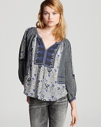 A collection of boho prints mix-and-match on this Rebeca Taylor blouse for a spirit inspired by the 1970s. Rock the eclectic look with your favorite vintage jeans and roll out in high style. A collection of boho prints mix-and-match on this Rebeca Taylor blouse for a spirit inspired by the 1970s. Rock the eclectic look with your favorite vintage jeans and roll out in high style.