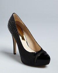 Cap off your look with these MICHAEL Michael Kors high heel pumps, that add a dose of shine to your daily style. Zipper piping adds a slick moto touch. Cap off your look with these MICHAEL Michael Kors high heel pumps, that add a dose of shine to your daily style. Zipper piping adds a slick moto touch.