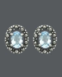 Button up your look in light blue hues. Genevieve & Grace stud earrings feature beautiful, oval-cut blue topaz gemstones (1-1/2 ct. t.w.) encircled by glittering marcasite. Crafted in sterling silver. Approximate diameter: 1/2 inch. Button up your look in light blue hues. Genevieve & Grace stud earrings feature beautiful, oval-cut blue topaz gemstones (1-1/2 ct. t.w.) encircled by glittering marcasite. Crafted in sterling silver. Approximate diameter: 1/2 inch.