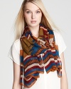 With a tribal print in seasonal hues and a bold striped border, this Theodora & Callum oblong scarf is a work of art.