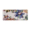 An opulent blue flower blooms from a backdrop of garden delights on the fresh, fun Eden oblong tray from Gien France.