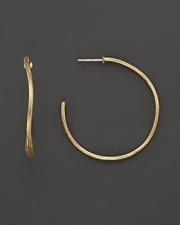 Large, undulating hoops of beautifully textured 18K yellow gold from the Jaipur collection by Marco Bicego. Large, undulating hoops of beautifully textured 18K yellow gold from the Jaipur collection by Marco Bicego.