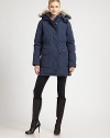 Designed with a woman's body in mind, this duck-feather down coat has storm flaps and a mid-thigh length.