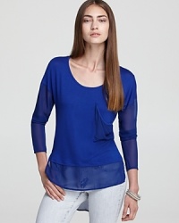 This slinky knit Vintage Havana top features a sheer asymmetric hem for a stylishly-illusive touch over denim. This slinky knit Vintage Havana top features a sheer asymmetric hem for a stylishly-illusive touch over denim.