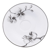 A captivating motif of lifelike orchids stands out in dramatic relief against a backdrop of vibrant white porcelain, giving this dinnerware from Michael Aram bold, artful presence.