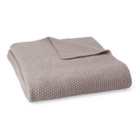 A cable knit throw adds a layer of warmth and luxurious softness. A cable knit throw adds a layer of warmth and luxurious softness.