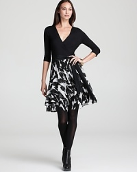 A study in contrasts, this DKNY systems dress goes bold in black and white. A solid top flaunts a flattering faux-wrap silhouette, while a flared skirt stuns with an abstract print. A study in contrasts, this DKNY systems dress goes bold in black and white. A solid top flaunts a flattering faux-wrap silhouette, while a flared skirt stuns with an abstract print.
