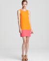 A neon pink dipped hem exudes colorful contrast against a melon-hued shift dress from ERIN Erin Fetherston.
