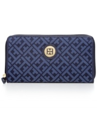 Pretty preppy. Tommy Hilfiger brings a fresh outlook to the everyday with this signature style, featuring monogram jacquard with golden accents. Slip it in your handbag or wear it on its own, for a stylish way to stay organized.