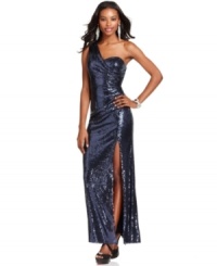Go for all-out glam in this sparkling gown from Xscape, sequined from top to bottom and featuring a flirty one-shoulder silhouette. Go for all-out glam in this sparkling gown from Xscape, sequined from top to bottom and featuring a flirty one-shoulder silhouette.