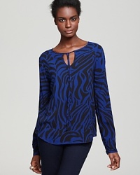 An exotic print lends a touch of wild to this Velvet by Graham & Spencer tunic top-the perfect update to fall office essentials. An exotic print lends a touch of wild to this Velvet by Graham & Spencer tunic top-the perfect update to fall office essentials.