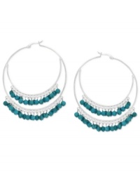 A stunning statement, twice over. These double hoop earrings are set in sterling silver and dazzle with beautiful turquoise (3/8 ct. t.w.) beads. Approximate diameter: 2 inches. A stunning statement, twice over. These double hoop earrings are set in sterling silver and dazzle with beautiful turquoise (3/8 ct. t.w.) beads. Approximate diameter: 2 inches.
