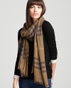 In a khaki green and lavender Burberry check, this oblong scarf offers lightweight luxe with its sheer, gauzy fabrication.