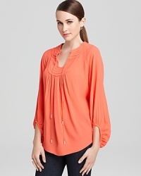 This peasant-style DIANE von FURSTENBERG top offers a sophisticated take on boho-chic with stylish lace-through neck ties and a rounded ladylike hem. This peasant-style DIANE von FURSTENBERG top offers a sophisticated take on boho-chic with stylish lace-through neck ties and a rounded ladylike hem.