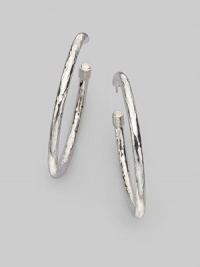 Slender sterling silver hoops with a lustrous hammered finish and cuffed caps. Sterling silver Diameter, about 2 Post back Imported