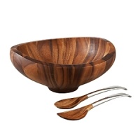 Irresistible to the touch and the eye, the Butterfly salad bowl and server set lends serene beauty to fresh greens and ensures breezy functionality for the cook. Created for Nambé by designer Sean O'Hara, the piece marries rich wood to lustrous alloy for a look that is both elemental and modern. Sweeping upward lines, a scooped interior, and a trim foot create a loft that pays tribute to the bowl's namesake. Its intelligent and thoughtful design highlights the acacia wood's compelling grain from all angles and underscores the undulating beauty of the rim. On the servers, elongated handles and subtle curves make tossing and serving both elegant and efficient. An ideal piece for people who love to entertain, the set makes a truly lovely gift. Irresistible to the touch and the eye, the Butterfly salad bowl and server set lends serene beauty to fresh greens and ensures breezy functionality for the cook. Created for Nambé by designer Sean O'Hara, the piece marries rich wood to lustrous alloy for a look that is both elemental and modern. Sweeping upward lines, a scooped interior, and a trim foot create a loft that pays tribute to the bowl's namesake. Its intelligent and thoughtful design highlights the acacia wood's compelling grain from all angles and underscores the undulating beauty of the rim. On the servers, elongated handles and subtle curves make tossing and serving both elegant and efficient. An ideal piece for people who love to entertain, the set makes a truly lovely gift.