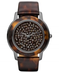 A modern watch design from DKNY with eye-catching neutral-hued stones at the dial. A modern watch design from DKNY with eye-catching neutral-hued stones at the dial.