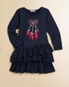 This adorable dress sports asymmetrical ruffles and an embroidered heart-shaped dreamcatcher motif.ScoopneckLong sleevesPull-on styleThree-tiered asymmetrical ruffle hem95% rayon/5% spandexMachine washImported