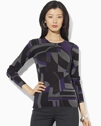 A lustrous silk-and-cashmere construction lends sultry appeal to a classic crewneck sweater. A lustrous silk-and-cashmere construction lends sultry appeal to a classic crewneck sweater.