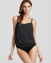 Miraclesuit's blouson design creates the illusion of two pieces. A graphic polka dot print adds optical interest, while the sleek, solid bottom smoothes and slims.
