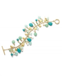 Let spring come early with the sweet blue and green hues of the Green Valley bracelet. Lauren by Ralph Lauren's serene style combines clusters of reconstituted turquoise, cultured freshwater pearls (4 mm) and gold accent discs. Setting and toggle clasp crafted in gold tone mixed metal. Approximate length: 7-1/2 inches. Let spring come early with the sweet blue and green hues of the Green Valley bracelet. Lauren by Ralph Lauren's serene style combines clusters of reconstituted turquoise, cultured freshwater pearls (4 mm) and gold accent discs. Setting and toggle clasp crafted in gold tone mixed metal. Approximate length: 7-1/2 inches.