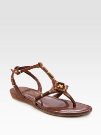 Textured leather straps with elaborate beading, a thong front and an adjustable ankle strap. Leather upperLeather liningRubber solePadded insoleImportedOUR FIT MODEL RECOMMENDS ordering true size. Textured leather straps with elaborate beading, a thong front and an adjustable ankle strap. Leather upperLeather liningRubber solePadded insoleImportedOUR FIT MODEL RECOMMENDS ordering true size.