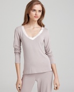 A long sleeve pajama top with a satin trim V-neckline. Pair it with Calvin Klein's matching pajama pants to complete the look.