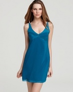 A V-neck chemise featuring a pleated front and draping back.