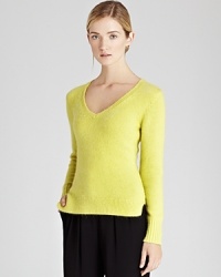 Elevate your every day look with this fluffy angora-blend sweater with a sensually deep v neck, a stylish exposed seam at center back and small side slits at the hem. Elevate your every day look with this fluffy angora-blend sweater with a sensually deep v neck, a stylish exposed seam at center back and small side slits at the hem.