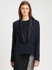 A modern variation on the traditional tuxedo, with feminine touches including an extended satin collar A modern variation on the traditional tuxedo, with feminine touches including an extended satin collar