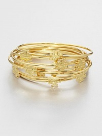 Stacked set of ten bangles with goldplated logo medallions for a simple, layered look. 16K goldplated brassDiameter, about 2½Slip-on styleImported Stacked set of ten bangles with goldplated logo medallions for a simple, layered look. 16K goldplated brassDiameter, about 2½Slip-on styleImported