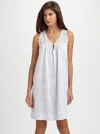 A back pleat and lace yoke embellishment add definition to a classic chemise. A back pleat and lace yoke embellishment add definition to a classic chemise.