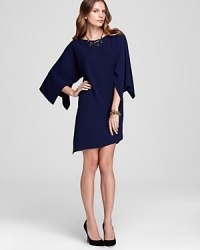 Evoke modern elegance in this T Tahari dress flaunting a chic asymmetric silhouette emboldened by oversized sleeves. Garnish with gold accents and captivate at cocktail hour. Evoke modern elegance in this T Tahari dress flaunting a chic asymmetric silhouette emboldened by oversized sleeves. Garnish with gold accents and captivate at cocktail hour.