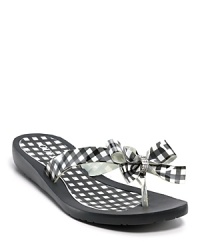 Preppy gingham lends a cheerful touch to these casual yet oh-so-ladylike flip flops from GUESS. Preppy gingham lends a cheerful touch to these casual yet oh-so-ladylike flip flops from GUESS.