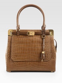 Luxurious crocodile embossed deer leather in a roomy top-handle carryall, accented with radiant hardware and contrast leather trim.Double leather top handles, 7½ dropTop zip closureProtective metal feetThree inner compartmentsOne outside flap pocketOne inside zip pocketTwo inside open pocketsFully lined13½W X 12H X 6DImported