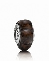 Scalloped carving brings added texture to this earthy wooded bead. Logo-engraved sterling silver trim displays the PANDORA signature.